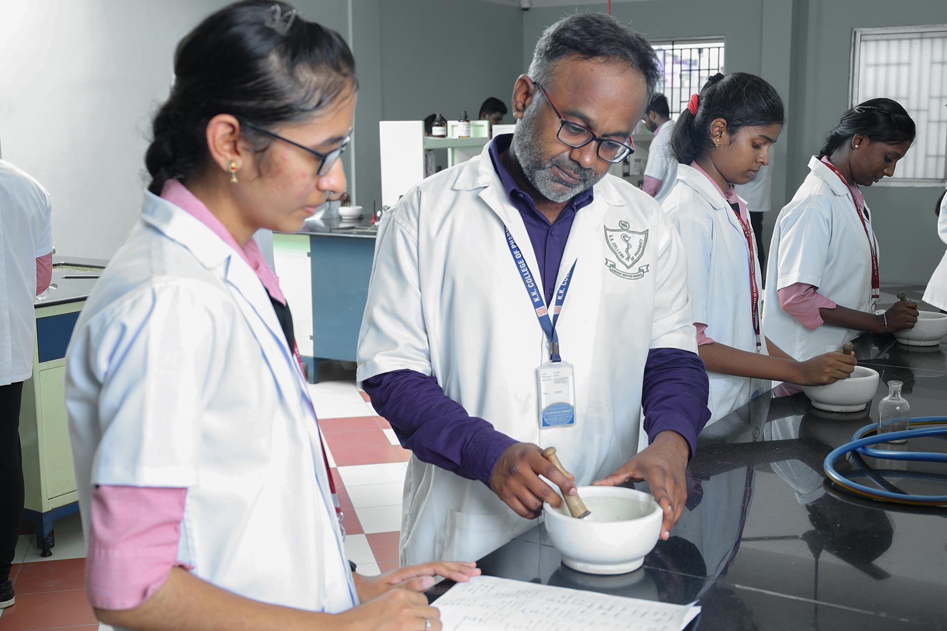 Teacher with Student at KK College of Pharmacy Lab